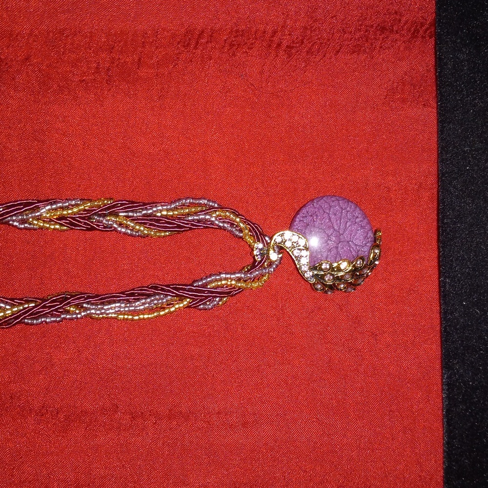 Braided necklace with flashy pendant